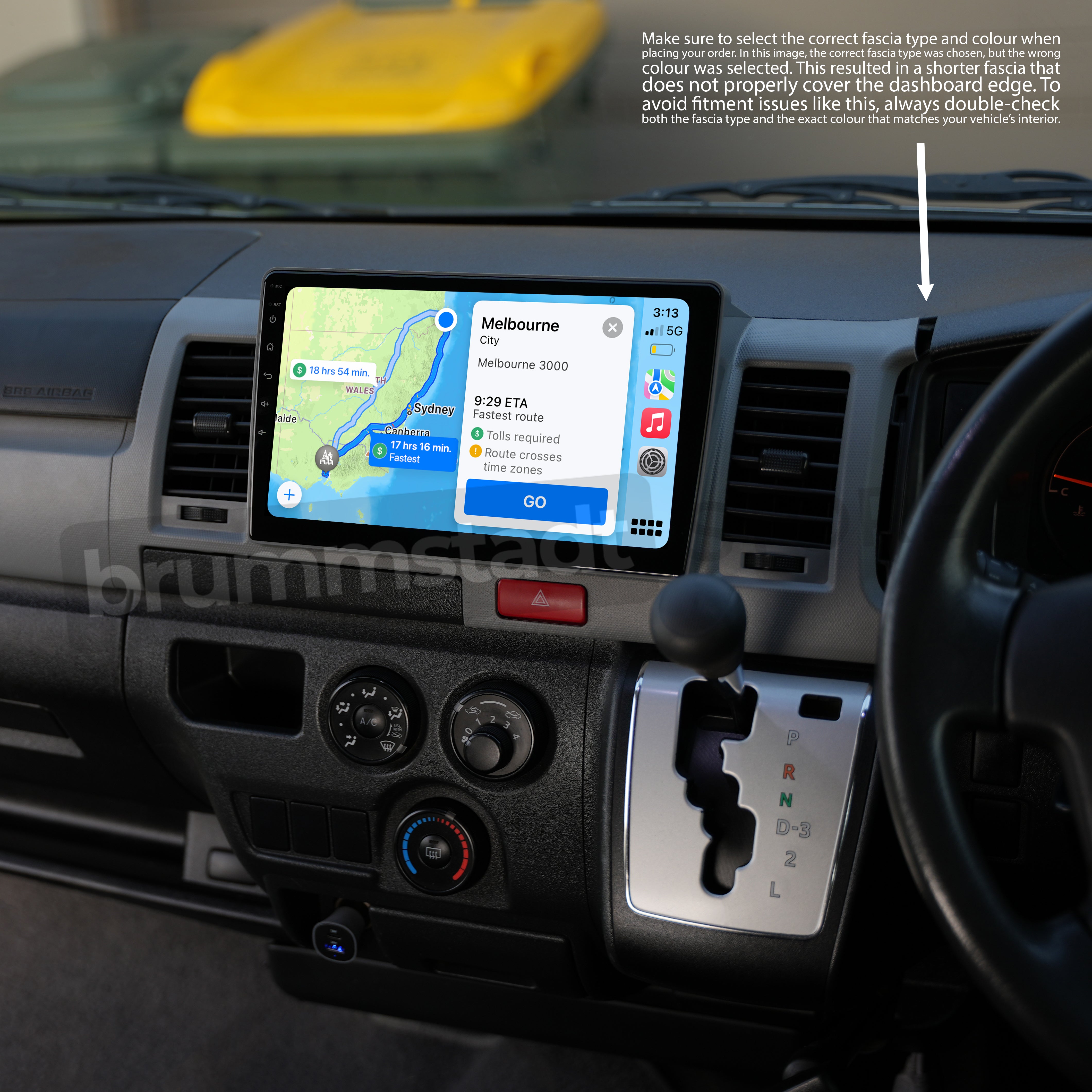 Interior of a Toyota HiAce H200 featuring a CarPlay and Android Auto head unit upgrade installed in the dashboard. The screen displays navigation directions to Melbourne. A silver fascia frame surrounds the unit, but the colour mismatch leads to a gap near the top right corner, highlighting the importance of selecting the correct fascia type and colour for a seamless fit.